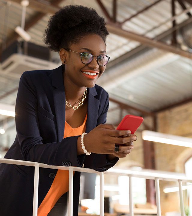 with-bright-lips-dark-skinned-stylish-young-woman-with-bright-lips-holding-her-smartphone Girl looking at smartphone, happy about NET 30 Business Accounts